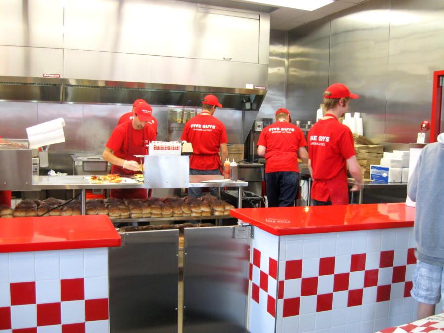 Five Guys employees making burgers for hungry customers