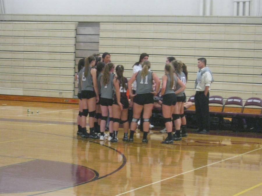 Girls volleyball huddles during a Chelmsford timeout.