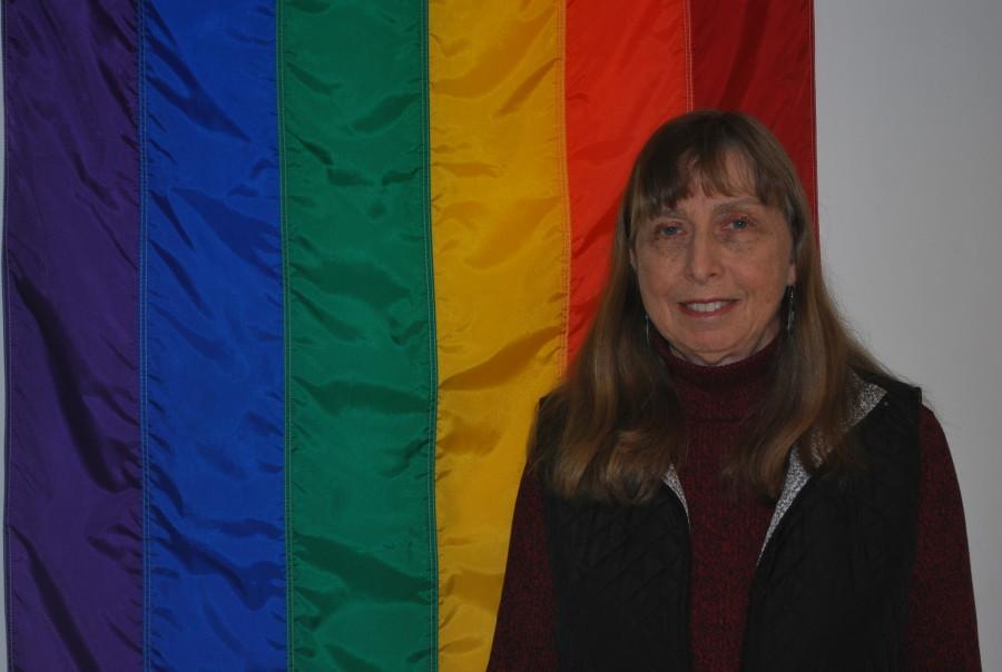 Susan Beers in her office, besides the GLBT flag.