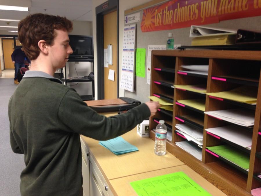 A senior submits his forms for senior privileges to be approved.