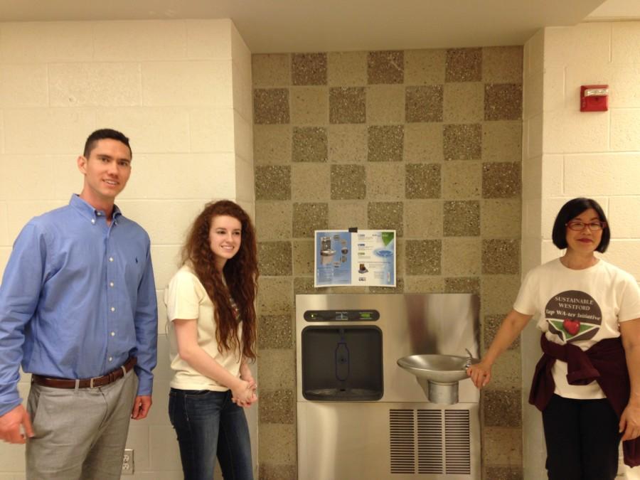 From left to right: Matt Thomas, Emily Wood and Gloria Gilbert with the brand new water system near the main gym at WA.
