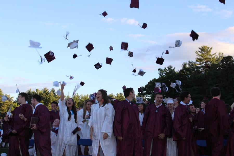 Class of 2014 throwing their caps into the air at the end of graduation. 