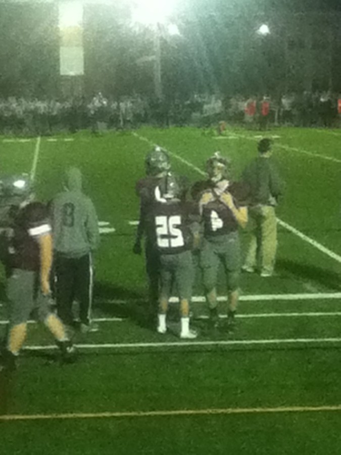 Westford players and coaches watching on the sidelines.