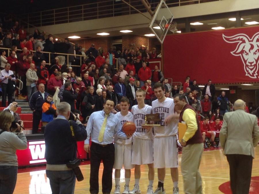 McCord holds the trophy alongside teammates, Bramanti, and principal Antonelli.