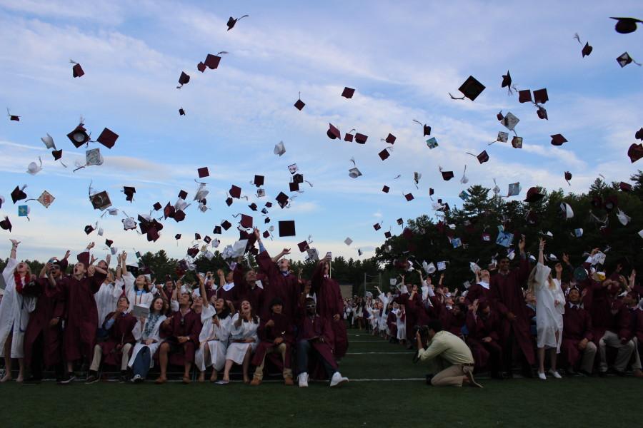 Seniors throwing caps into the air