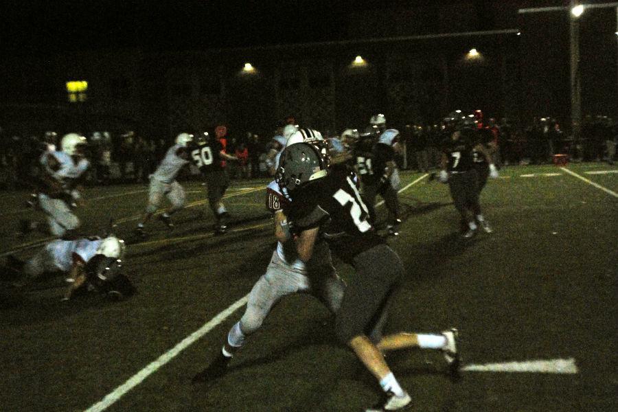 A WA defender attempts to get to the Reading quarterback.