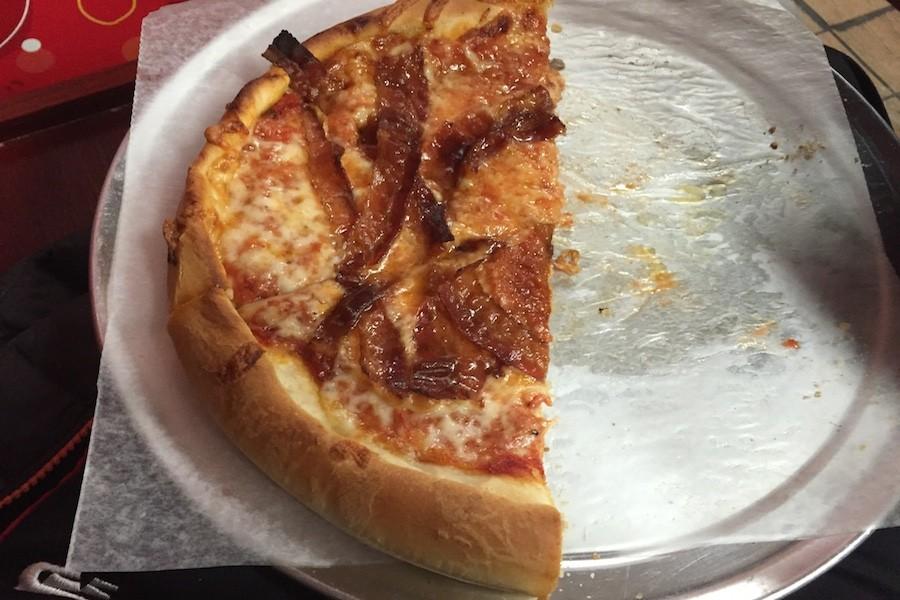 A couple slices of bacon pizza