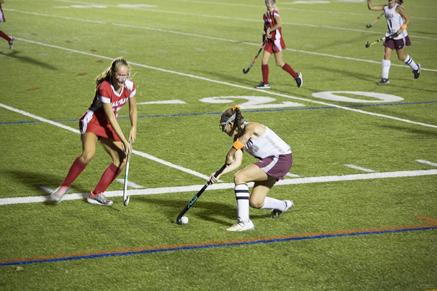 Junior Hannah Keefe drags back the bal to avoid an incoming Waltham defender 