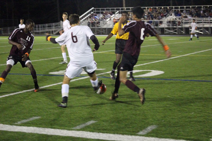 Senior Benjamin Pazienza tries to steal the ball from a Chelmsford player