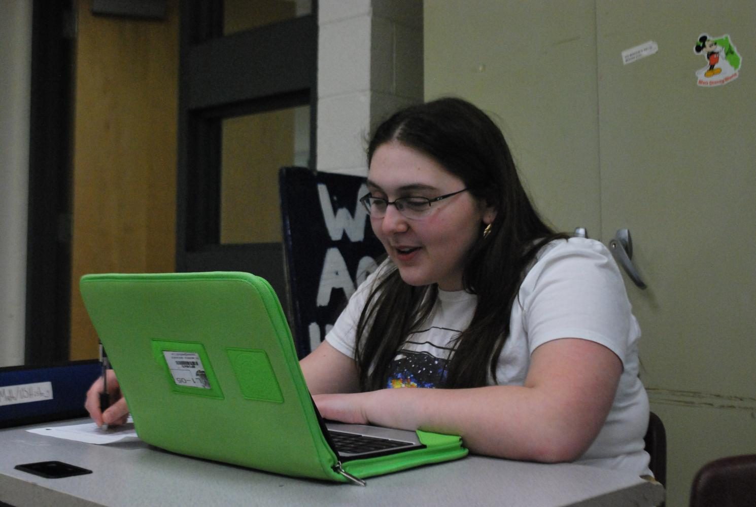 Junior Naomi Szabo-Wexler uses a Chromebook from the loaner station.