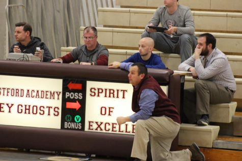 Head Coach Chris Bramanti watches his team from the scorers table. 