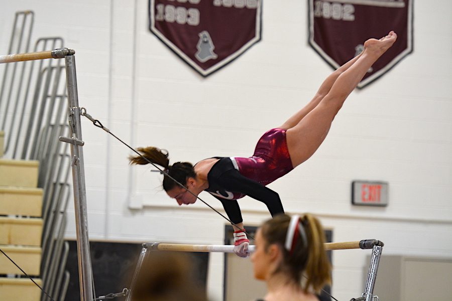 Senior Hannah Kettering casts on the uneven bars.