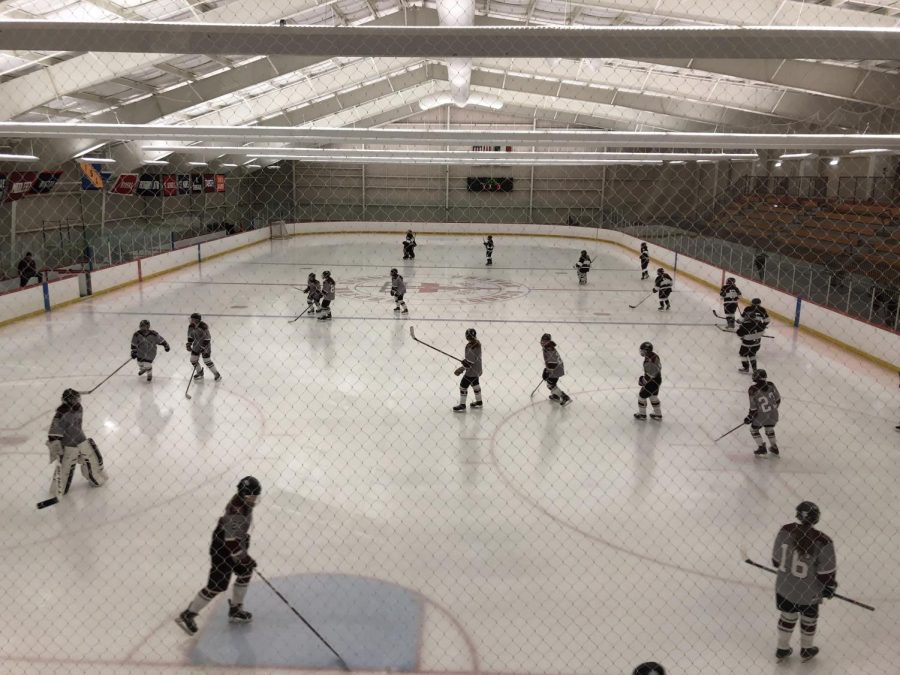 The WA Girls Hockey Team warms up before the third period.