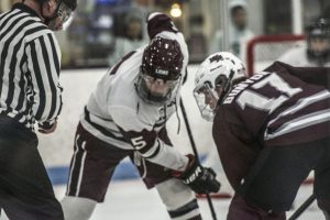 Sophomore forward player Jason Bunyon faces off with a Chelmsford player at the start of the second period.