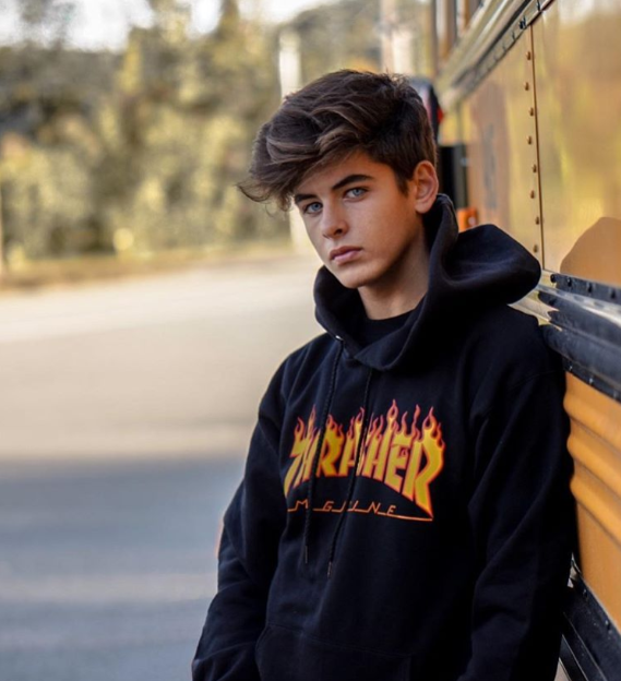 An Instagram picture of Víctor near a school bus