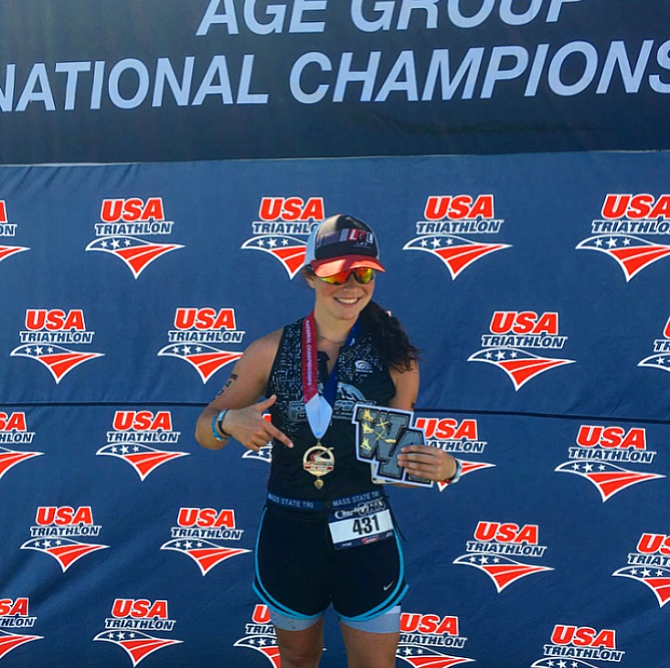 Vallone displays an award from the Age Group National Championships