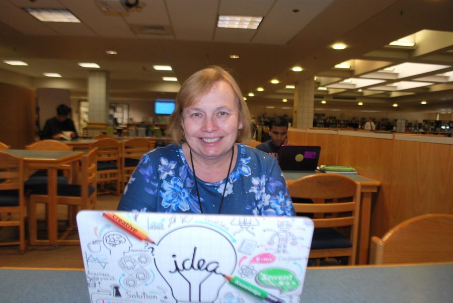 Marianne Butterline poses for a picture in the school library