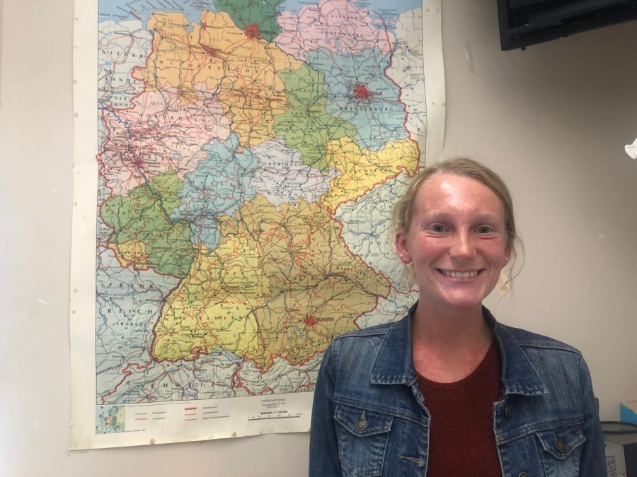 German teacher Ashley Smith poses in front of a map of Germany.