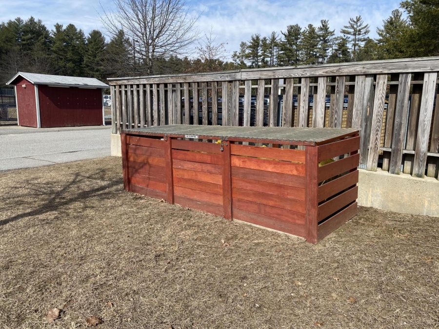 The compost bins are outside Westford Academy near the outdoor eating area.