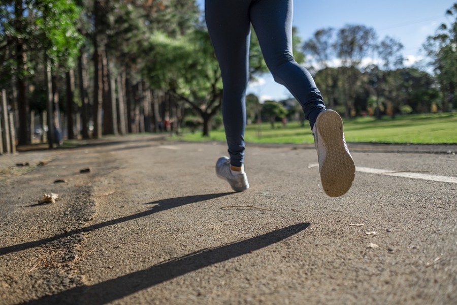 A woman enjoys taking a run through a neighborhood