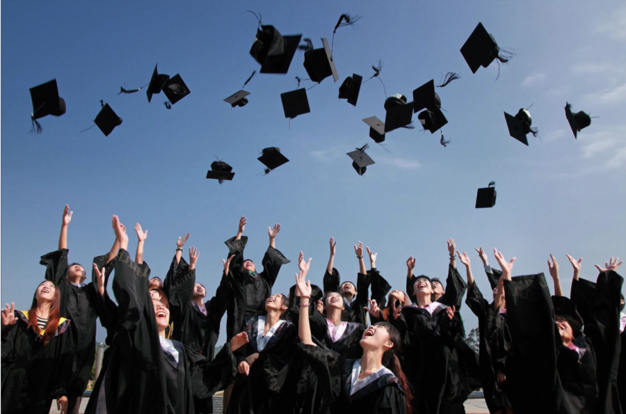 Students throw up their graduation hats, excited for the next chapter of their lives.