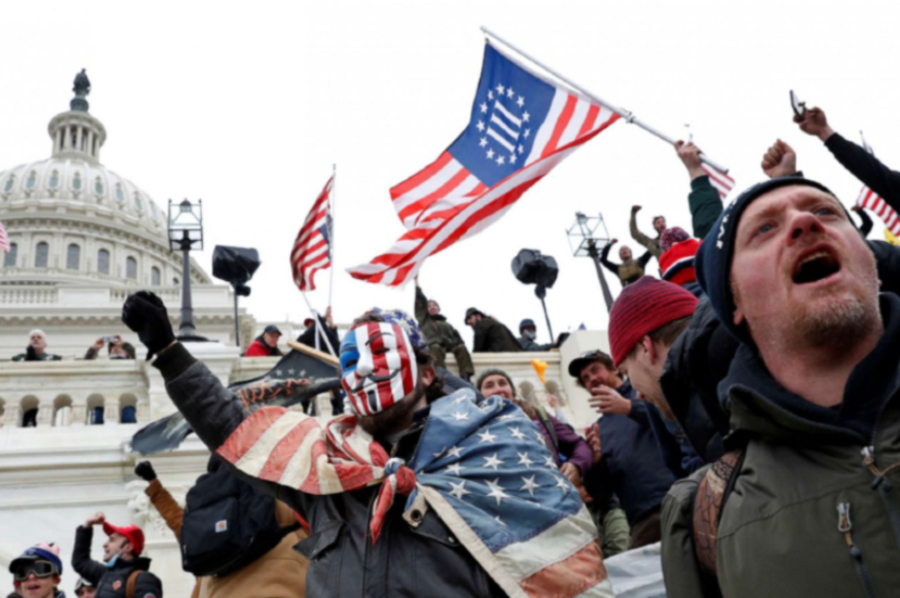 Rioters wave the "III Percent" flag outside of the Capitol.