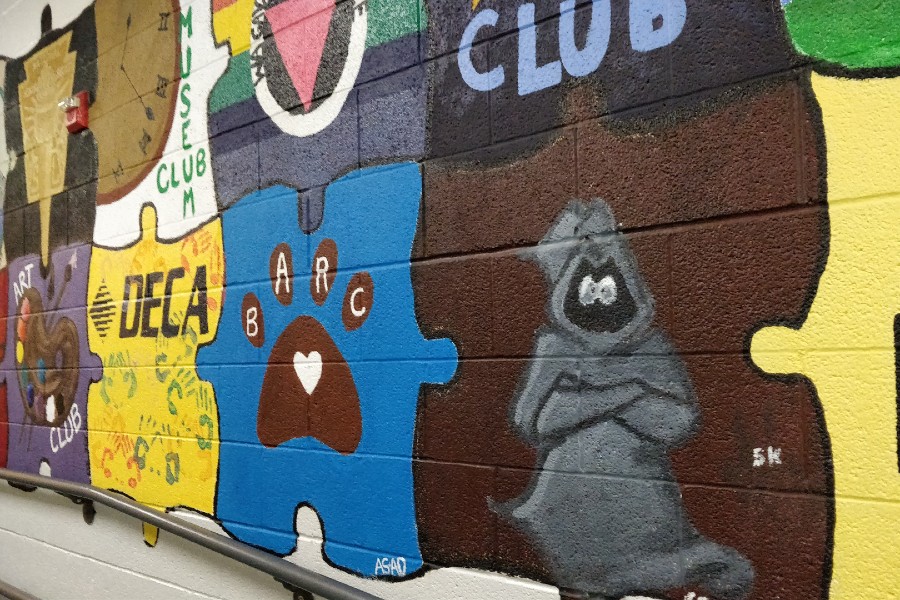 The Grey Ghost painting that is part of the mural that is on the wall that leads to the cafeteria. If the mascot image is changed, the mural may need to be painted over.
