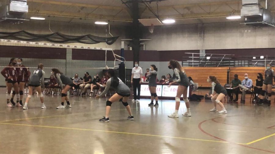 The Girls Varsity team readys for the incoming serve by Lowell High School. 
