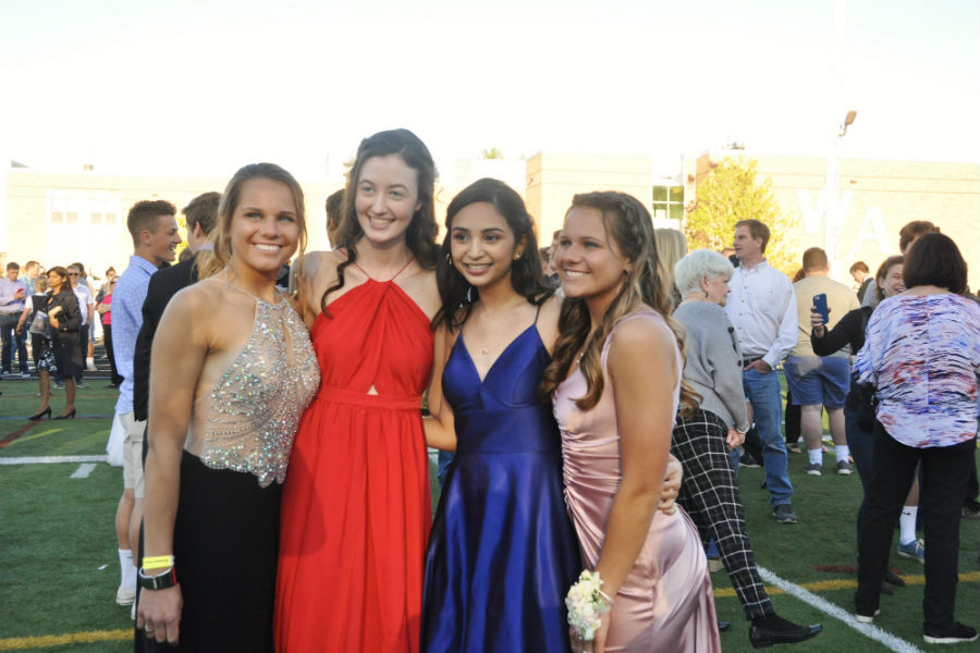 Juniors Amanda Chavalier, Alex Whitney, Mahi Kandage, and Jessica Chavalier posing in their formal dresses during their Cotillion in 2020. 