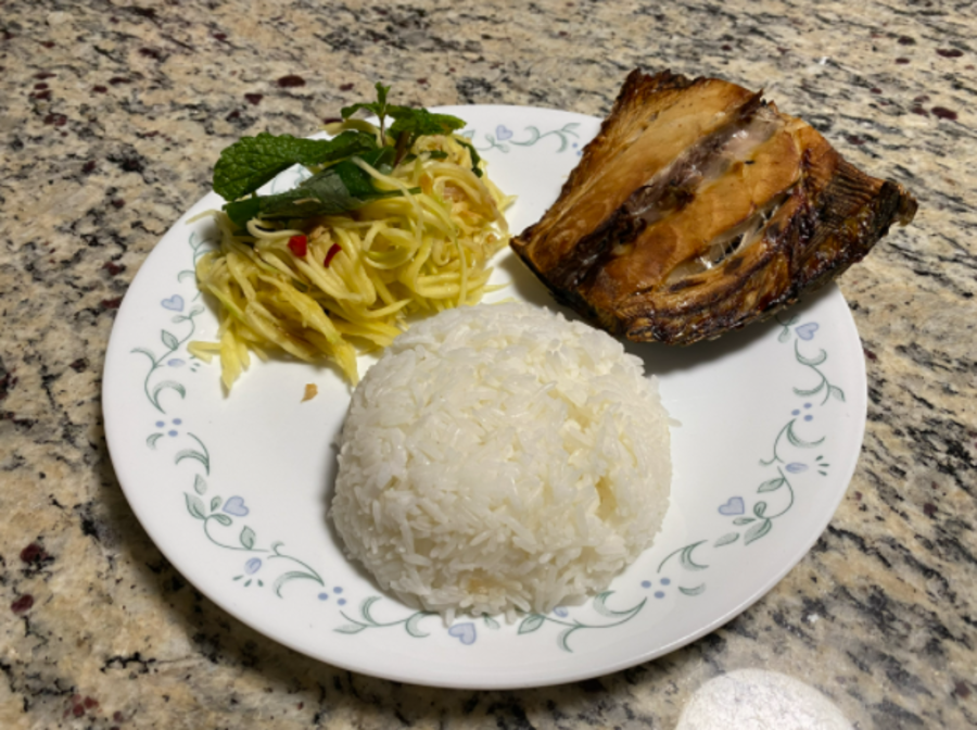 A common Khmer dish of mango salad with mint (left), white rice (middle), and baked mackerel fish (right).