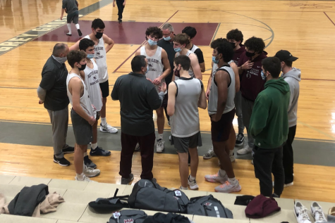 WA Boys Varsity Basketball team regroups at the end of practice to discuss strategy.