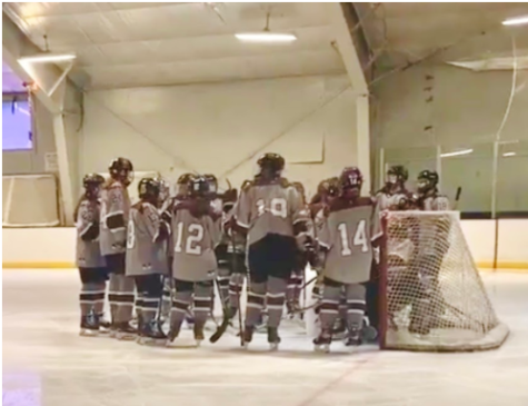 Westford-Littleton girls hockey team huddles before game starts.