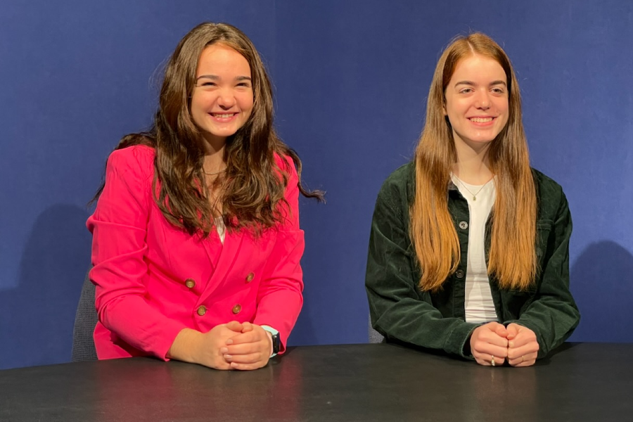 Vivian (left) and Charlotte (right) Aeder pose at the anchoring chairs at the WABC studio. 