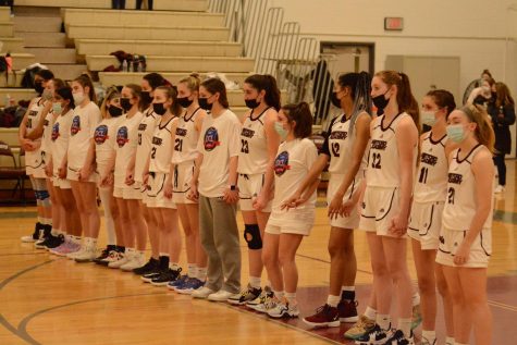 WA girls basketball team stands for the National Anthem before the game. 