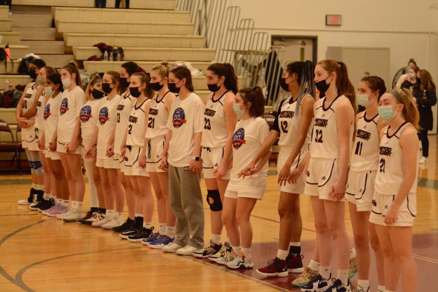 WA Girls Basketball stands in a line for the National Anthem.