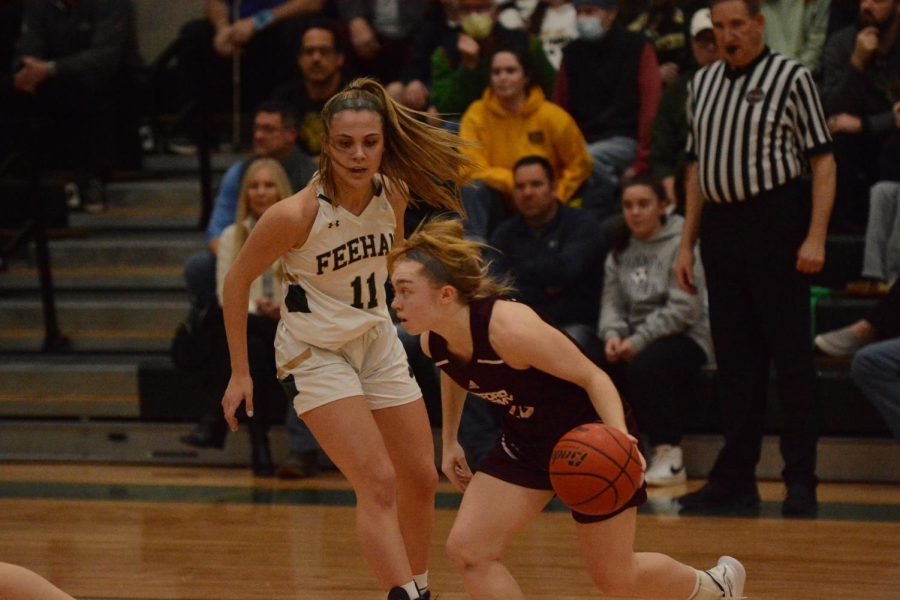 Senior captain Carly Davey dashes past her Bishop-Feehan defender to get the ball closer to her WA teammates.