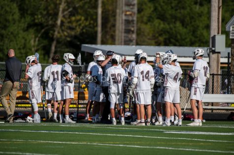 The 2021 WA Lacrosse team huddles during a game. Many up-and-coming stars for the 2022 season made their debut last season.