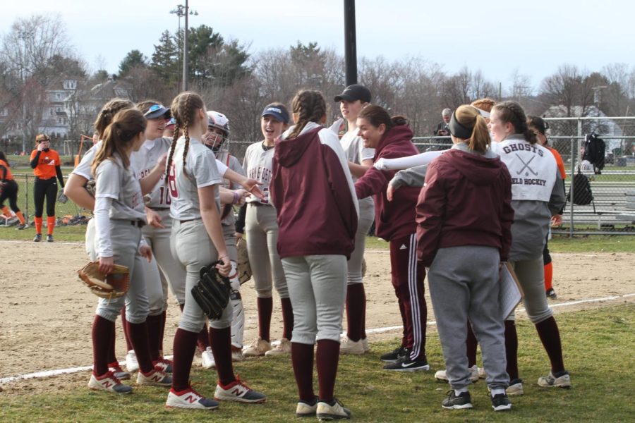 The Westford Varsity Softball team takes a huddle during their scrimmage against Newton North.