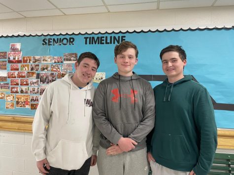 From left to right, juniors TJ  Bonica, Brendan Connell, and Keegan Connell smile for the camera. 
