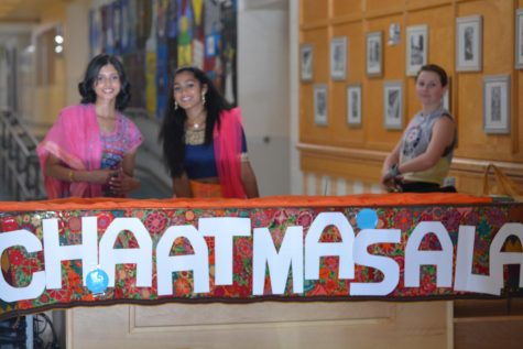 Senior Manasvi Iyengar (left) and sophomore Sreya Binu (right) work at the check-in booth in the senior lobby for Chaat Masala. 