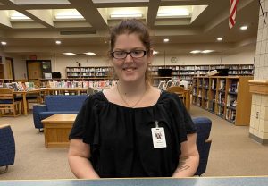 Cara McCarthy smiles for a picture in the library.