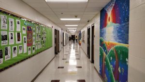 Students walk through the history hallway at WA.