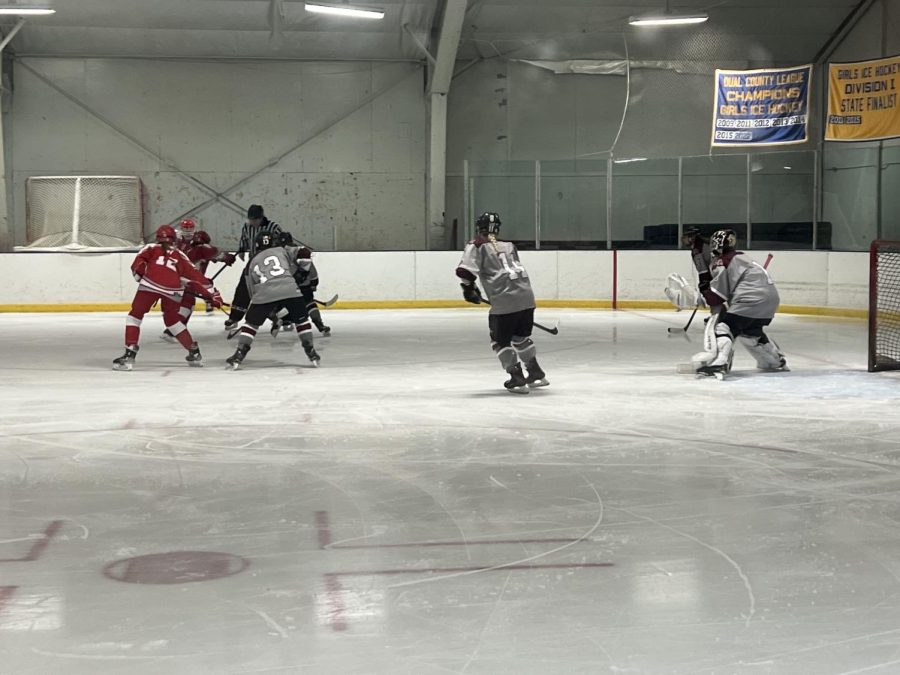 WA Girls Ice Hockey lines up for a face-off in their 2-1 victory over Waltham.
