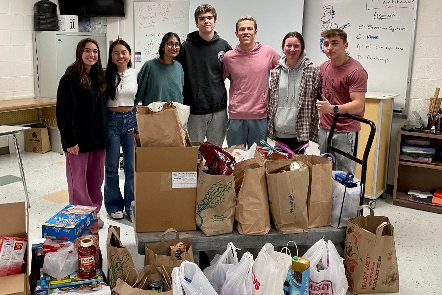 A group seniors with the entirety of the cans received during the food drive. 