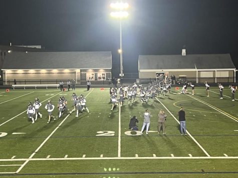 WA Football runs out onto the field during a Friday night home game. This is just one of the many fun high school events that you do not want to miss.