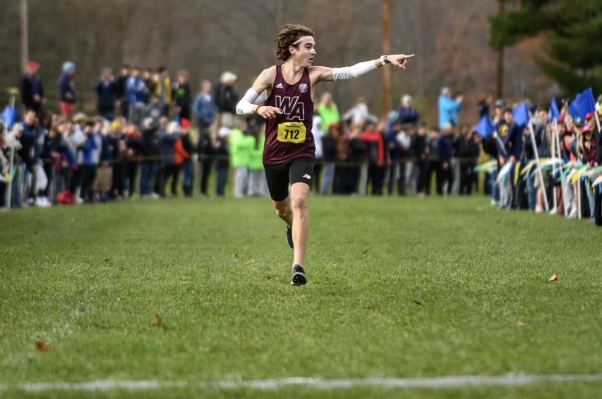 Bergeron+celebrates+only+a+few+strides+away+from+crossing+the+finish+line+at+the+MIAA+State+Championship.