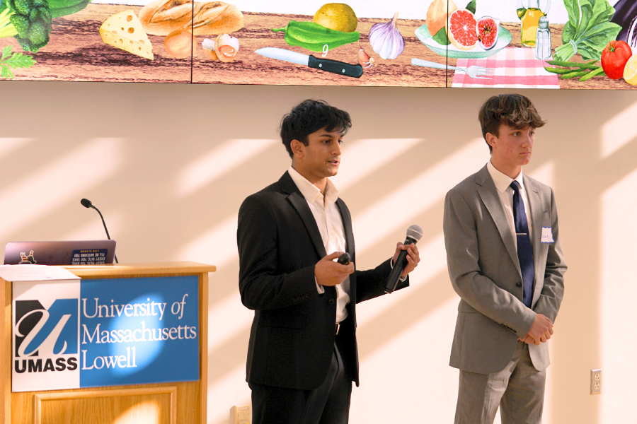Seniors Devesh Khamitkar and Adam Wedlake present their product to the judges at the UMass Lowell Differencemaker Rocket Pitch Event.