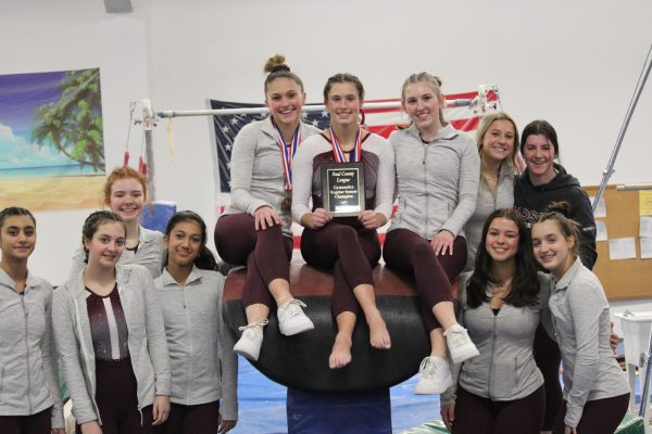 WA gymnastics team gathers for team picture being champions of regular season.