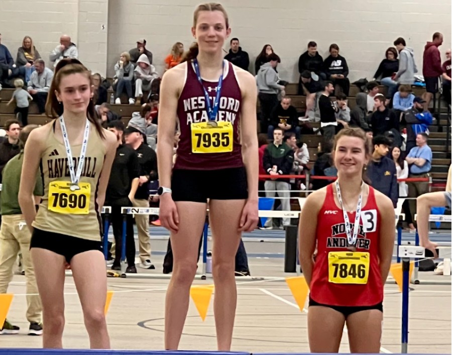 Hennessy stands on the podium after winning first place in the 1000-meter race at the Massachusetts State Championship.