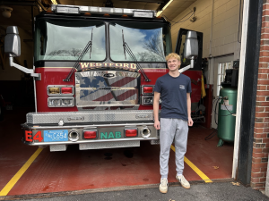Marshall stands in front of a firetruck at the Nabnasset Fire Station.